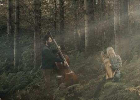 image of 2 musicians in a forest
